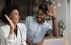 Happy African couple reading on laptop good news gesturing giving high five, feel excited by online bid win, celebrate lottery victory. Achieved new opportunity, loan approval, ecommerce sale concept